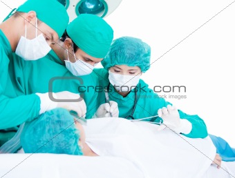 Medicalteam making an operation using surgery equipment on a pat