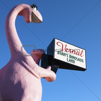 Pink dinosaur holding sign for city of Vernal, Utah.