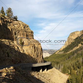 Highway winding through steep Wyoming mountains.