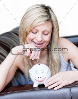 Radiant woman using a piggybank 