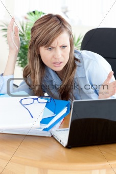 Stressed businesswoman looking at the laptop 