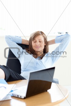 Relaxed businesswoman looking at the laptop