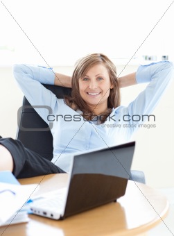 Smiling businesswoman looking at the laptop 