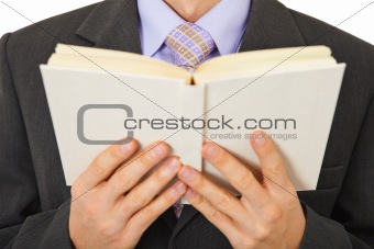 Man in suit reads book