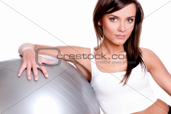 Young woman in doing fitness exercises with pilates gym ball 