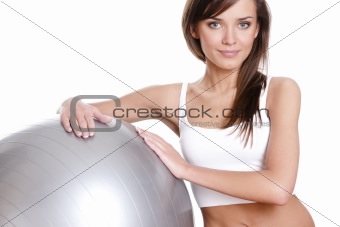 Young woman in doing fitness exercises with pilates gym ball 
