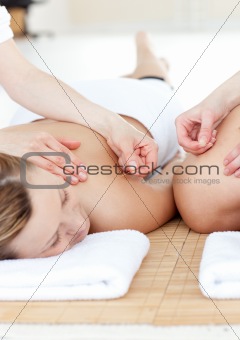 Smiling couple in an acupuncture therapy