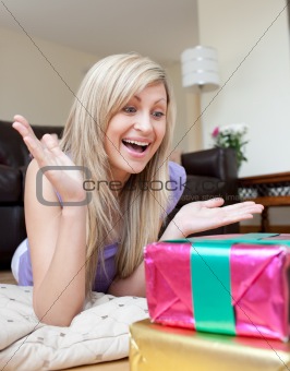 Astonished woman looking at a present 