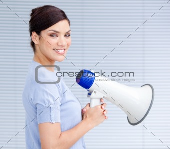 Smiling businesswoman holding a megaphone
