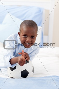 Cute little boy holding a soccer ball 