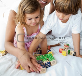 Close-up of brother and sister playing with cube toys 