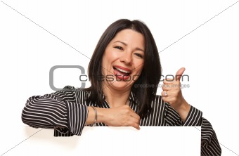 Attractive Smiling Multiethnic Woman Leaning on Blank White Sign with Thumbs Up Isolated on a White Background.
