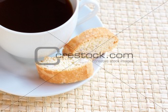 Cup of hot coffee and almond biscotti cookies