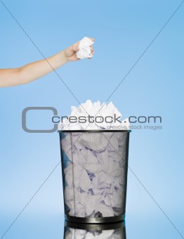 trowing a paper into a wastebasket