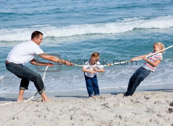 Happy family playing tug of war