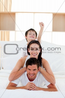 Cute little boy and his parents having fun