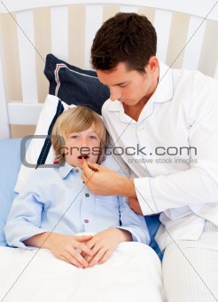 Affectionate father checking his son's temperature
