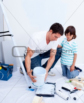 Attentive father and his son decorating their house