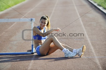 happy young woman on athletic race track