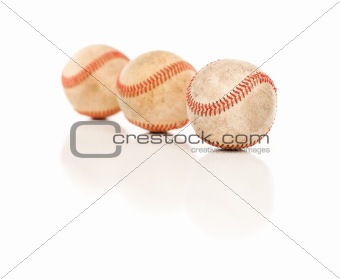 Three Baseballs Isolated on a Reflective White Background.