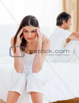 Sad couple sitting sitting separately after having a row 