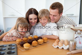 Jolly family presenting their muffins