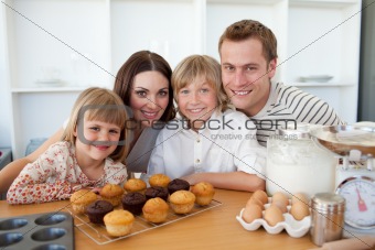 Happy family presenting their muffins