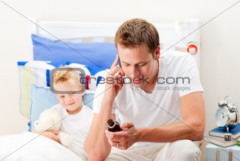 Attentive man looking after his sick son