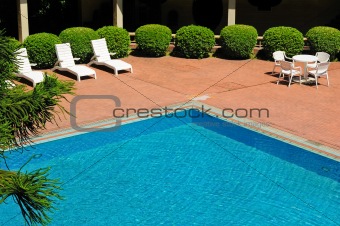 swimming pool and chaise longues