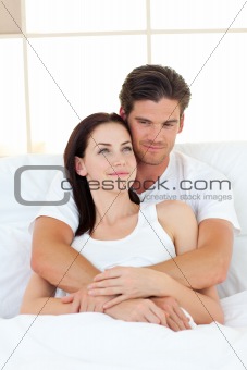 Portrait of happy lovers hugging in their bed