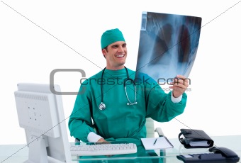 Positive surgeon looking at X-ray in his office