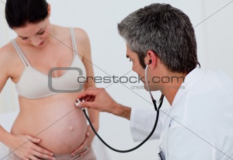 Brunette pregnant woman examined by her gynecologist