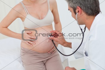 Portrait of a pregnant woman examined by her gynecologist