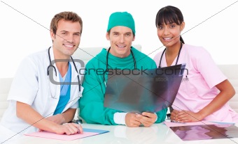 Smiling medical team looking at X-ray