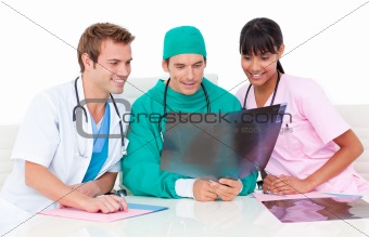 Positive male doctors looking at X-Ray in hospital