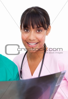 Etnic nurse looking at X-ray