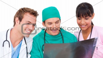 Enthusiastic medical team looking at X-ray