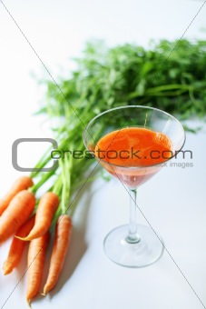 shot of fresh squeezed carrot juice on white