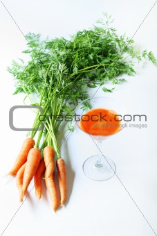 shot of organic fresh carrot juice on white