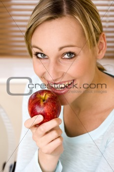 Beautiful Young Woman Holding an Apple and Watching Direct to Ca