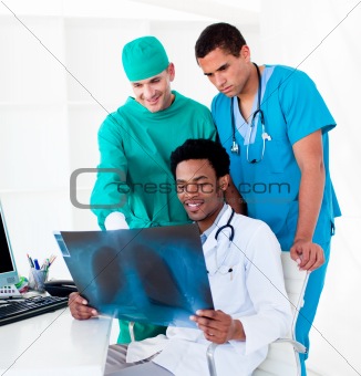 Positive male doctors looking at X-Ray