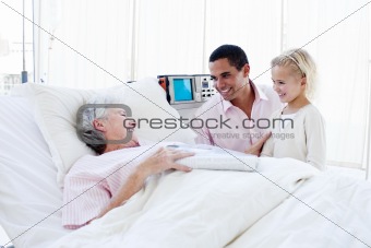 Adorable little girl with her father visiting her grandmother