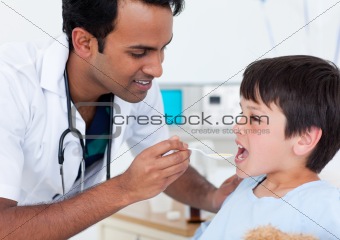 Attractive doctor giving medicine to a little boy