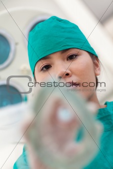 Serious nurse applying gas mask to a patient