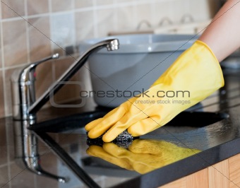 Close-up of a woman cleaning a kitchen
