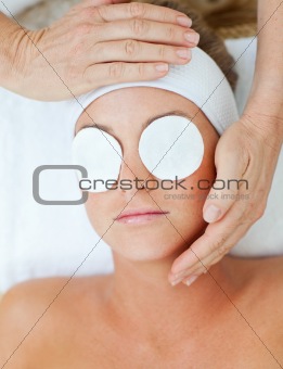Positive woman relaxing with an head massage