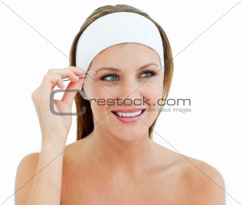 Charming woman using tweezers