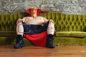 Mexican wrestler sitting on a couch