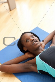 Radiant woman in gym outfit excercising 