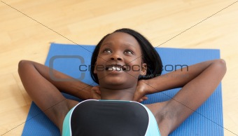 Happy woman in gym outfit excercising 